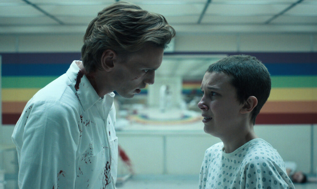 STRANGER THINGS. (L to R) Jamie Campbell Bower as Peter Ballard and Millie Bobby Brown as Eleven in STRANGER THINGS. Cr. Courtesy of Netflix © 2022